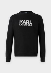Sudadera negra de manga larga con el logo blanco "KARL LAGERFELD" y un gráfico estilizado del perfil en el pecho, cuello redondo, puños y dobladillo acanalados.