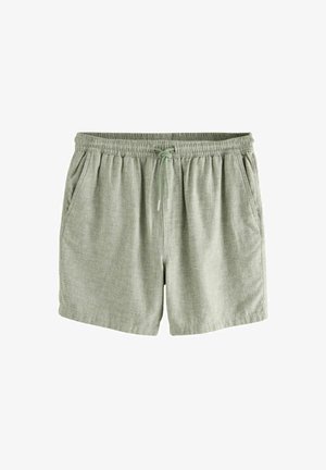 Light green linen shorts with a loose fit, elastic waistband, and drawstring. Features side pockets and a textured fabric.
