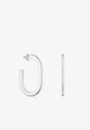 Orecchini a cerchio in argento con una forma rotonda e liscia, caratterizzati da un leggero design a U. Dispongono di una chiusura sicura e di una finitura lucida. Stile minimalista.