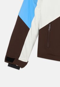 Bruin, wit en blauw kleur-geblokkeerde jas met een ritszak, elastische manchetten en een gladde, zachte textuur. Functioneel en modern ontwerp.
