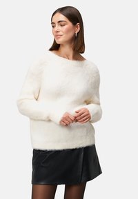 White, fluffy pullover sweater with a wide neckline and long sleeves, paired with a black leather skirt. Soft texture and relaxed fit.