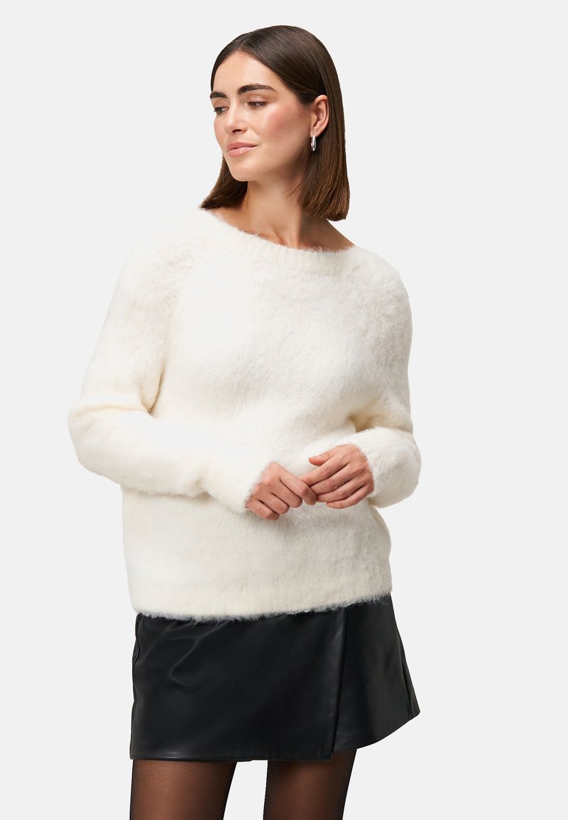 White, fluffy pullover sweater with a wide neckline and long sleeves, paired with a black leather skirt. Soft texture and relaxed fit.