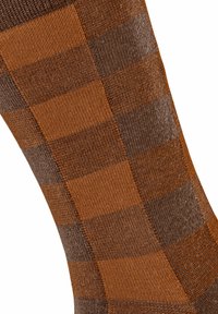 Calzini a strisce marroni e arancioni con un motivo a scacchi. Realizzati in materiale lavorato a maglia, presentano variazioni di texture e colore alternate.