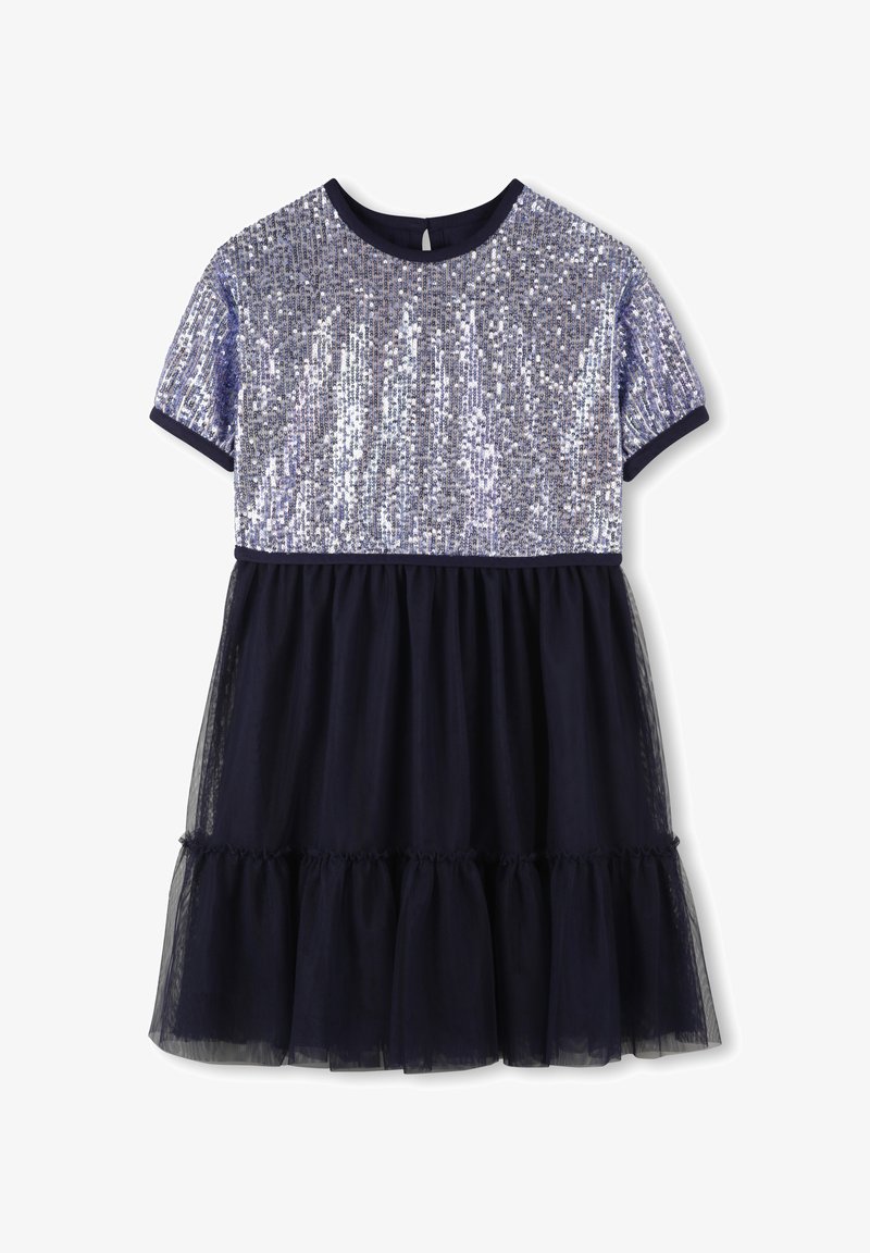 Kortermet kjole med en skinnende sølvpaljett-bodice og en marineblå tyllskjørt med volangkant. Rund hals med marineblå kant.