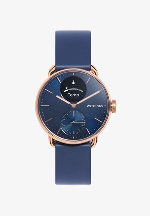 Withings watch featuring a rose gold case, blue dial with temperature display, and a blue silicone strap. Includes a sub-dial for additional metrics.