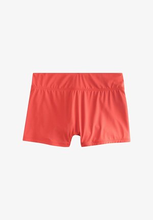 Raudoni sportiniai šortai iš tamprios, lygios medžiagos. Sukurti su plačia, elastinga juosmens juosta ir prigludusia forma.