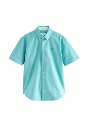 Krátky rukáv, košeľa s gombíkmi z ľahkej modrej bavlny, s logom palmy v námorníckej farbe a vzorovaným vnútorným golierom. Klasický strih a dizajn.