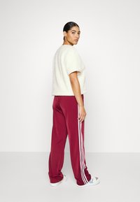 adidas Originals ADICOLOR CLASSICS FIREBIRD PRIME - Tracksuit bottoms - shadow red