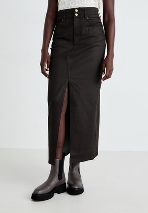 Brown denim maxi skirt with front slit, two gold buttons at the waistband, paired with gray ankle boots featuring a chunky black sole.