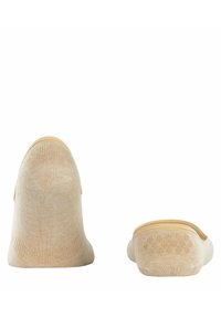 Beige, niedrig geschnittene Socken aus weichem, strukturiertem Material mit einem gerippten Bündchen und nahtlosem Zehenbereich. Glatte Oberfläche mit feinen Stichdetails.
