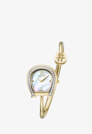 Montre-bracelet Aigner ton or avec cadran en forme de fer à cheval, accents en diamant, cadran en nacre et aiguilles dorées minimalistes sur un bracelet jonc.