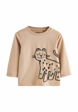 Maglietta a maniche lunghe beige in cotone, con una grafica di un leopardo contornato di nero, con macchie e un'espressione sorridente sul davanti.