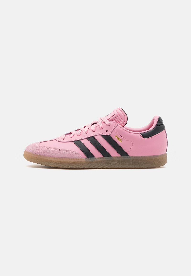 Pink leather sneakers with black accents, three black stripes on the side, and a gum sole. Features padded collar and laces.