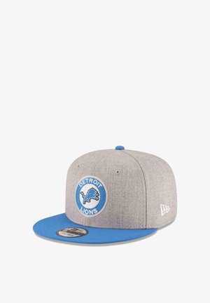 Gray and blue snapback cap with Detroit Lions logo patch on front and New Era logo embroidery on side.