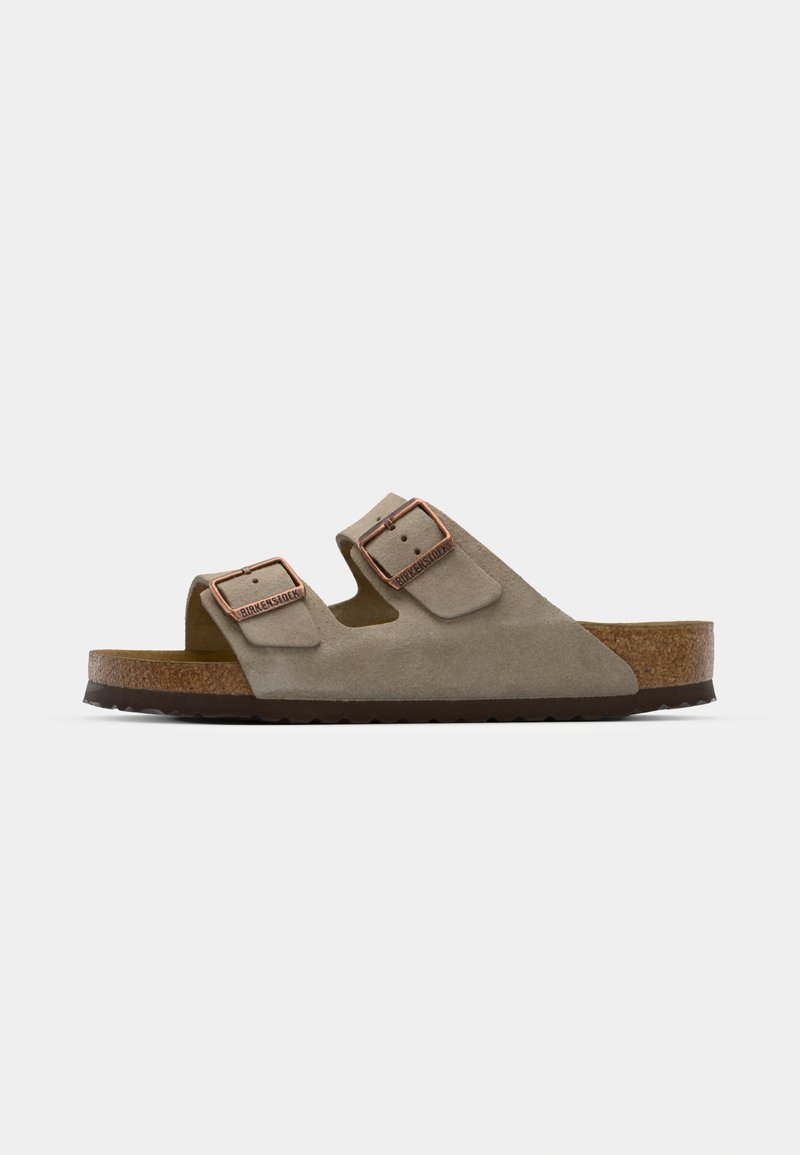 Suede slide sandal in light grey with two adjustable buckles, a cork midsole, and a textured rubber outsole.