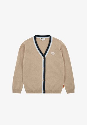 Cardigan beige hecho de material suave con escote en V, detalles a rayas en azul marino y azul claro, y un emblema de oso en el pecho izquierdo.