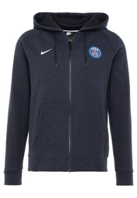Sudadera navy con cremallera, fabricada en un tejido suave, con capucha ajustable, bolsillos frontales y un logo azul de París en el pecho; incluye el swoosh de Nike.