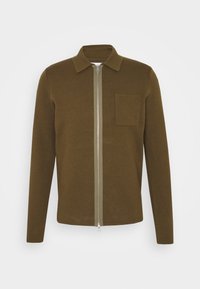 Veste marron à fermeture éclair avec manches longues, col pointu et une poche poitrine gauche. Fabriquée en tissu texturé, dotée d'une fermeture éclair argentée.