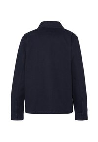 Veste noire à manches longues vue de dos, avec col et poignets boutonnés, sur un fond blanc uni.