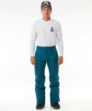 Teal sneeuwbroek met een losse pasvorm, ritsen aan de zijkanten, gecombineerd met een wit long sleeve shirt en een gebreide bruine beanie met een skibril.