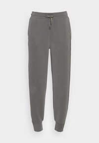 Mörkgrå tapered sweatpants med elastisk midja och dragsko, med smalnade anklar, visade mot en vit bakgrund.
