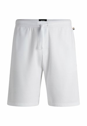 Shorts blancs en tissu texturé, dotés d'une taille élastique avec cordon de serrage et de poches latérales. Design simple et pratique.