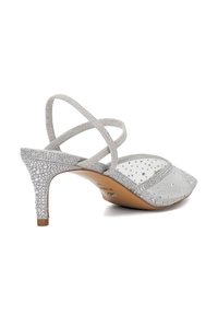 Silver heeled sandals with crisscross straps, textured fabric, and rhinestone detailing on the heel. Pointed toe design.
