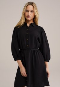 Rochie neagră cămașă cu guler, deschidere butonată în față și talie elastică. Prezintă mâneci tip balon și un material texturat.
