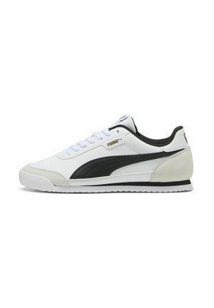 White leather sneaker with black and grey accents, round toe, flat sole, and textured side panel. Features lace closure and logo detail.