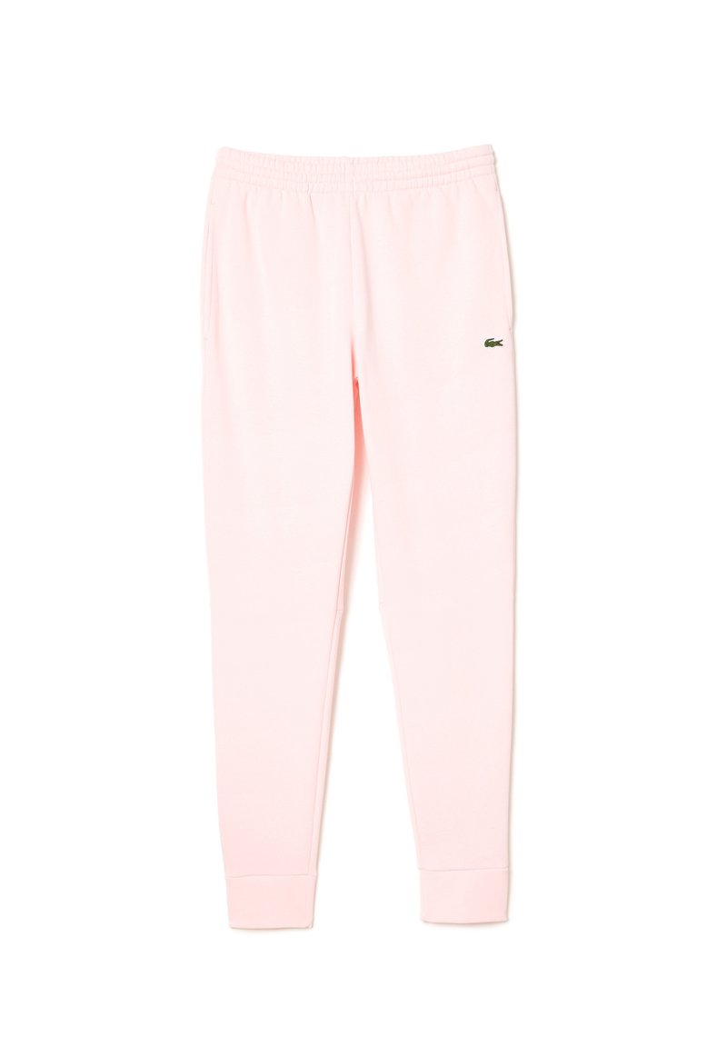 Pantalones de chándal rosas hechos de una tela suave, con una cinturilla y puños elásticos, y un pequeño logo verde de Lacoste en la pierna izquierda.