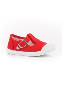 Zapato Mary Jane de lona roja con suela de goma blanca, correa ajustable con hebilla y diseño de punta redonda. Presenta costuras en contraste y forro transpirable.