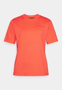 T-shirt à manches courtes corail en coton. Encolure ronde avec détail du logo sur la poitrine. Texture lisse et coupe régulière.
