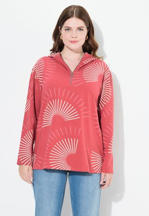 Pull-over zippé rouge avec des manches longues et un ourlet arrondi. Décoré de motifs en forme d'éventail blancs, fabriqué dans un tissu doux et léger.