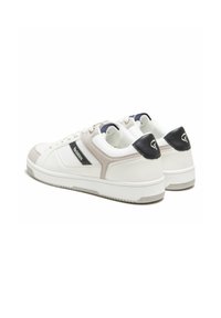 Des baskets blanches avec des accents gris et un talon bleu marine, fabriquées en cuir et en mesh. Le design comprend un logo et une semelle en caoutchouc texturée.
