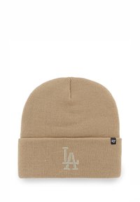 Beige knit beanie with a rolled cuff, featuring embroidered "LA" logo in light color and woven brand tag on the side.