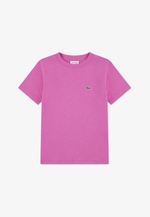 Maglietta di cotone rosa con scollo tondo e maniche corte, con piccolo logo coccodrillo Lacoste verde sul petto a sinistra.