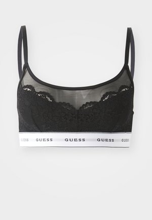 Black lace bralette with sheer material and adjustable straps. Features a white elastic band with "GUESS" logo. Floral lace detailing on cups.