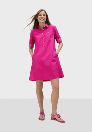 Pink cotton dress with collared neck and half sleeves, featuring front buttons, side pockets, and contrasting checkered cuffs.