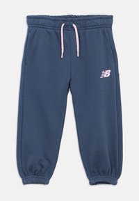 Navy blue sweatpants with elastic waistband and cuffs, light pink drawstring, side pockets, and a light pink New Balance logo on the left thigh.