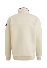 Veste légère blanche avec un col haut, des poignets et un ourlet côtelés, dotée d'une accent noir au col et d'un détail de couture à l'arrière.