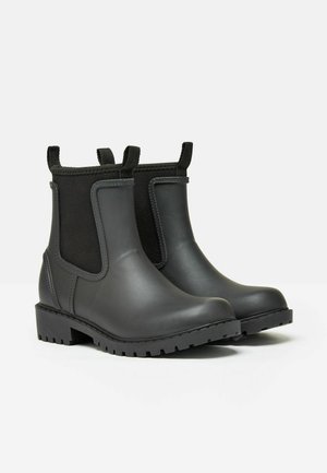 Schwarze Gummistiefel bis zum Knöchel mit elastischen seitlichen Einsätzen, strukturierten Sohlen und Schlaufenanzieh-Ösen für einfaches An- und Ausziehen. Glatte Oberfläche und robustes Design.