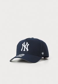Navy blue baseball cap made of fabric, featuring a prominent white embroidered NY logo on the front and a small 47 logo on the side.