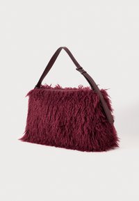 Burgunderfarbene Handtasche mit Felltextur in rechteckiger Form, ausgestattet mit einem braunen Ledertragegurt. Akzente aus fransigem Fell verleihen dem Design Tiefe.