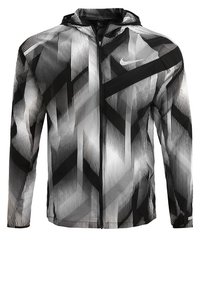 Letvægts hættejakke med et sort-hvidt geometrisk mønster, fremstillet af glat stof med lynlås foran.