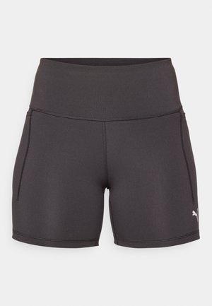 Sorte sportsbukser laget av elastisk, glatt stoff. Har høy midje og sidelommer. Hvit logo på nedre høyre side.