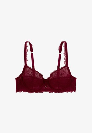 Soutien-gorge en dentelle bordeaux avec motif floral, bonnets à armatures, bretelles ajustables et bords frisottés. Présente un petit détail métallisé au centre.