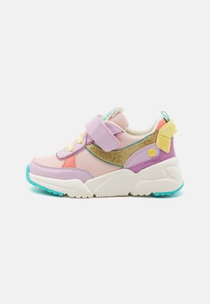 Colorful sneaker featuring a mix of pink, purple, and gold materials, velcro strap, mesh accents, and a thick white midsole with turquoise details.