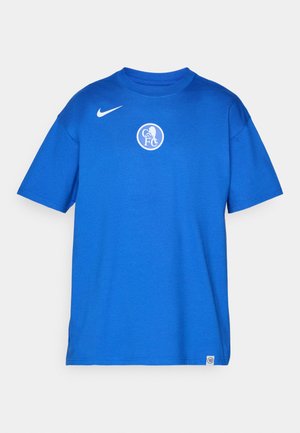 Blue cotton t-shirt featuring a round neckline, short sleeves, and a white circular logo on the chest. Nike swoosh in white on the left shoulder.