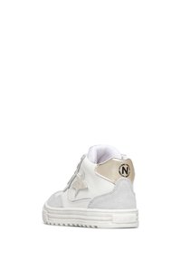 Bílé a šedé tenisky s hvězdičkovým detailem na boku a metalicky zlatým patním tabem, viděné z pravého zadního úhlu na bílém pozadí.