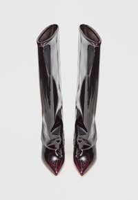 Stivali bordeaux lucidi al ginocchio con punta affusolata e design morbido. Texture liscia con finitura brillante. Nessun hardware o dettaglio visibile.